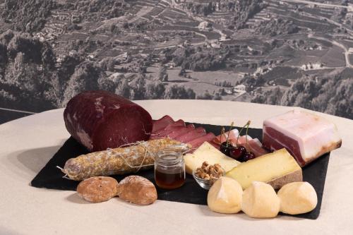 a tray of different types of cheese and meats at Locanda al Crap in Tresivio