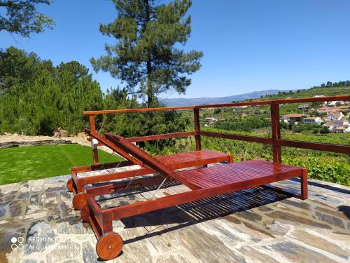 a red bench sitting on top of a ledge at Casa das Vinhas Velhas by Casa do Poço in Peso da Régua