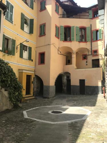 a building with a courtyard in front of it at C’era una Volta in Isolabona