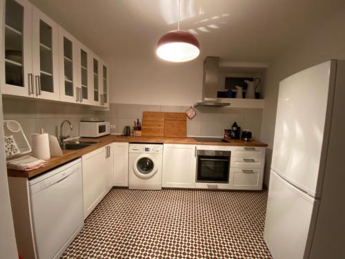 a kitchen with a white refrigerator and a dishwasher at Casa do Sétimo Passo in Marvão