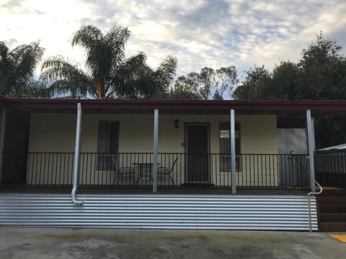 a large white building with a balcony on top of it at Echuca Holiday Units in Echuca