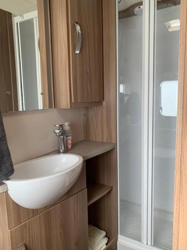 a bathroom with a sink and a shower at Caravan Glamping Accommodation in Te Awamutu