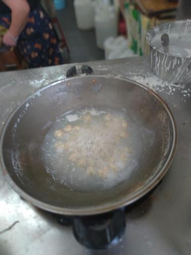 a frying pan on a counter with food in it at mei hao min su in Nangan