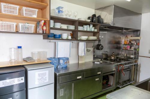 a kitchen with a sink and a stove at Niseko Ski Lodge - Hirafu in Kutchan
