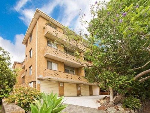 a large brick building with a garage at Accommodation Sydney Kogarah 2 Bedroom Budget Apartment with Balcony in Sydney