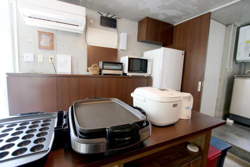 a kitchen with a toaster on a wooden counter at Kaze -SEVEN Hotels and Resorts- in Higashi