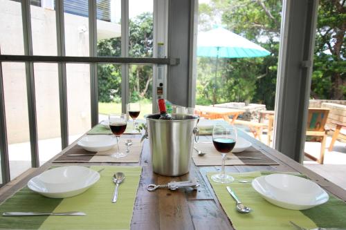a wooden table with glasses of wine on it at Kaze -SEVEN Hotels and Resorts- in Higashi