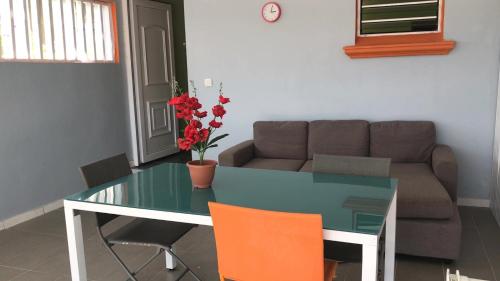 a living room with a glass table and a couch at Domaine De Titine in Bonneville