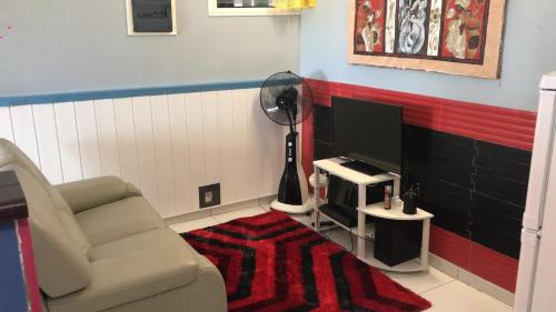 a living room with a chair and a flat screen tv at Domaine De Titine in Bonneville