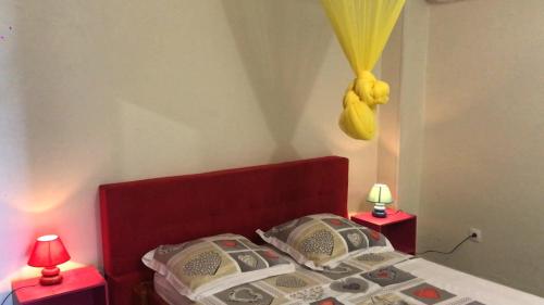 a bedroom with a bed with two red night stands at Domaine De Titine in Bonneville