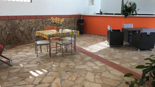 a table and chairs in a room with a stone floor at Domaine De Titine in Bonneville