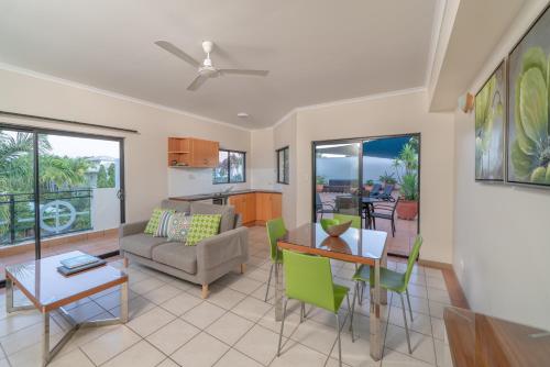 
a living room filled with furniture and a table at Regal Port Douglas in Port Douglas
