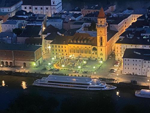 a city at night with a cruise ship in the water at Appartementhof Stadler in Pocking