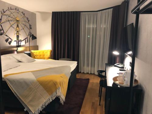 a hotel room with a bed and a table and a desk at Original Sokos Hotel Vaakuna Kouvola in Kouvola