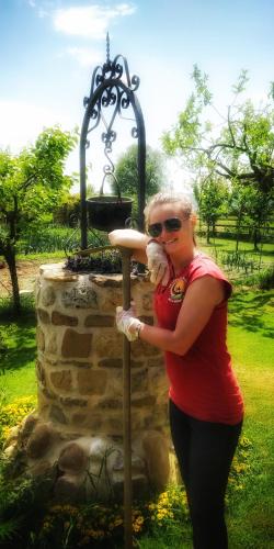 a woman holding a teddy bear in front of a fountain at La Luna nel Parco in Fano