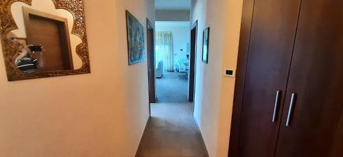 a hallway with a mirror on the wall and a hallway with a hallway at Relax vila žusterna in Koper