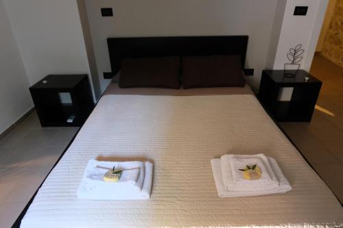 a bedroom with a bed with two towels on it at Il Miglio in Più in Castel di Tusa