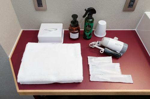 a table with towels and other items on it at BUNSHODO HOTEL in Fukuoka