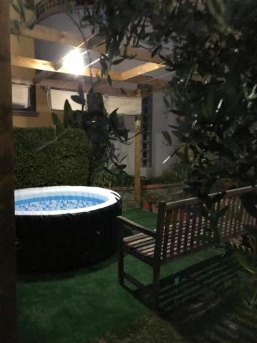 a bench sitting next to a large tub in a yard at Il Nespolo in Cavriglia