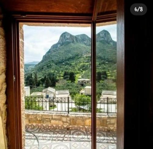 - une fenêtre avec vue sur la montagne dans l'établissement Luxurious Stone Apartment 2, à Kerá