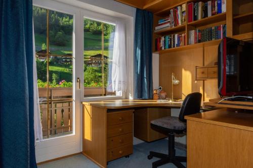 an office with a desk and a window with a view at Ferienwohnung Elfriede in Hopfgarten in Defereggen