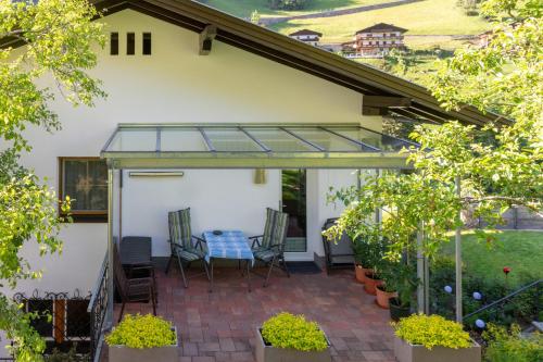 a conservatory with a table and chairs on a patio at Ferienwohnung Elfriede in Hopfgarten in Defereggen