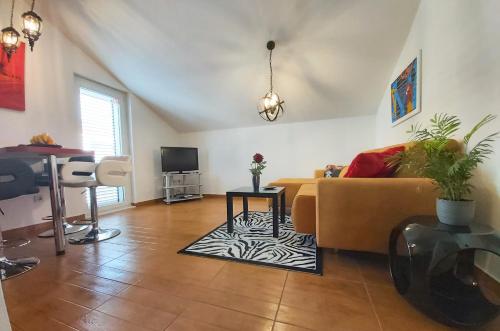 a living room with a couch and a table at Adria Apartments and Rooms in Dubrovnik