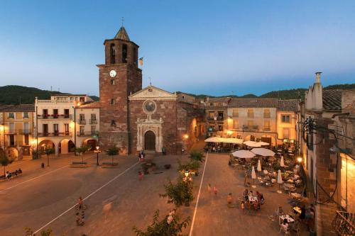 an old building with a clock tower in a town at Cal Tomaset in Prades
