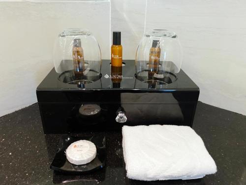 a table with two bottles of wine and a towel at UCSI Hotel Kuching in Kuching