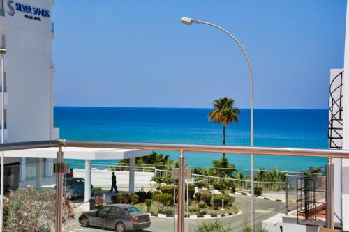 a view of the ocean from the balcony of a building at Seafront Protaras Villas in Protaras