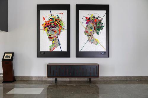 three paintings of a woman on a wall at Acanthus Cennet Barut Collection - Ultra All Inclusive in Side