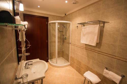 a bathroom with a shower and a sink at Hotel President in Montecatini Terme