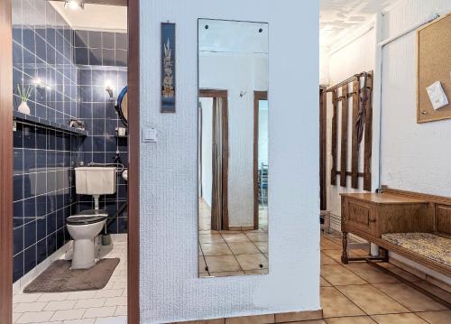 a bathroom with a toilet and a mirror at Mieszkanie Next - NoclegiSopot in Sopot