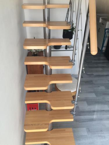 a set of wooden stairs in a room at Loft Zen Climatisé in Soustons