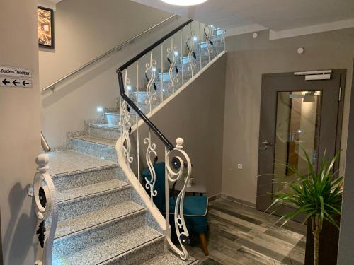 a staircase in a home with blue and white stairs at Hotel Bispinger Hof in Bispingen