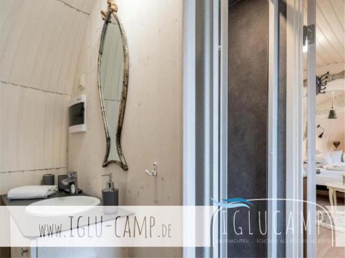 a bathroom with a sink and a mirror on the wall at Iglu Camp Heidewald in Sassenberg