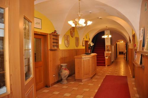 a hallway of a building with a vase on the floor at Hotel Residence Rosa in San Lugano