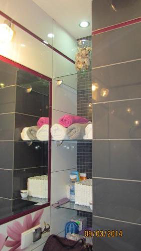 a bathroom with a mirror and some shelves with towels at jaren in Łukęcin