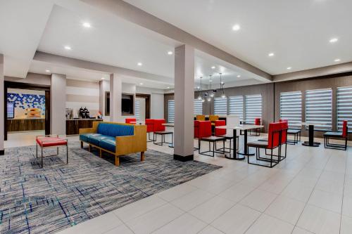 a lobby of a hospital with tables and chairs at La Quinta Inn & Suites by Wyndham Northlake Ft. Worth in Northlake