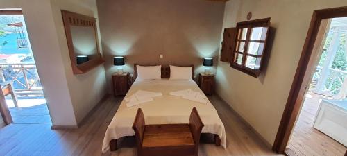 a bedroom with a large bed in a room at Akrotiri B&B in Pórto Káyio