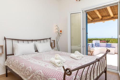 a bedroom with a bed with towels on it at Oneiric Harmony in Mikri Vigla