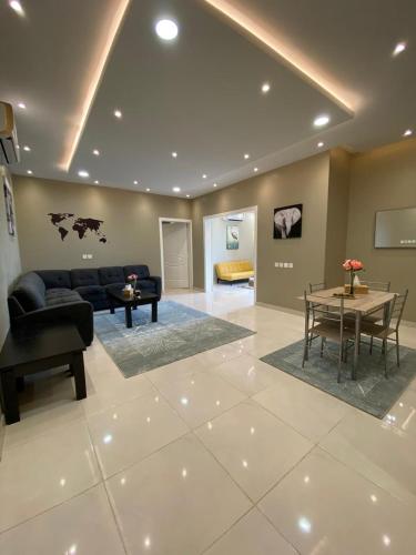 a living room with a couch and a table at A - 369 مقابل الراشد مول in Abha