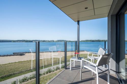 a balcony with a view of the beach and the ocean at Golden Lakes Hotel in Boussu-lez-Walcourt