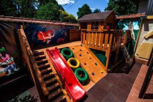 a childrens playground with a slide and a play structure at Hotel Golden House in Craiova