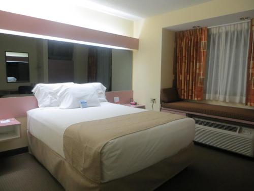 a hotel room with a large bed and a window at Cedar Bluff Inn in Knoxville