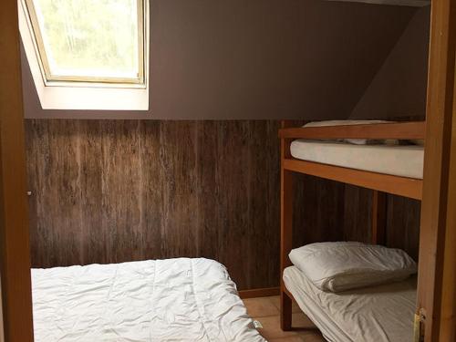 a bedroom with two bunk beds and a window at Les Pinées in Chateauroux-les-Alpes