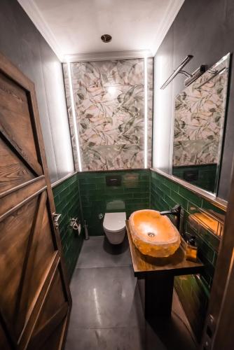 a bathroom with a wooden sink and a toilet at Murat Pasha Mansion in Dalyan