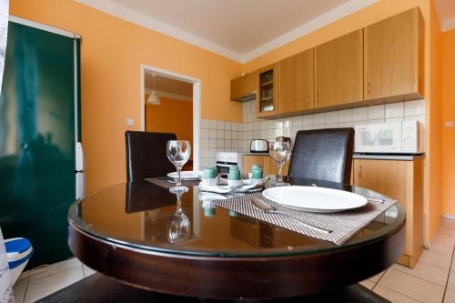 a dining room with a table and chairs and a kitchen at Apartments TGM 11 in Karlovy Vary