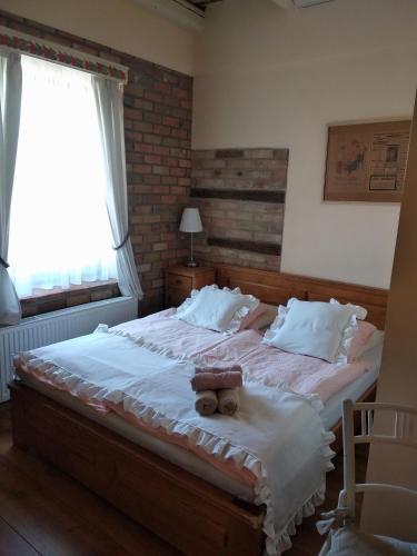 a bedroom with a bed with a teddy bear on it at U Anny Šmejdířky in Nymburk