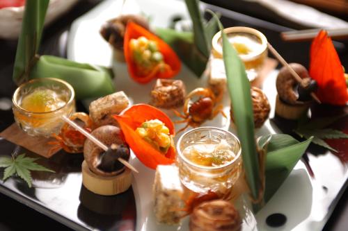 a tray of food on a table with peppers and vegetables at Biwako Ryokusuitei in Otsu